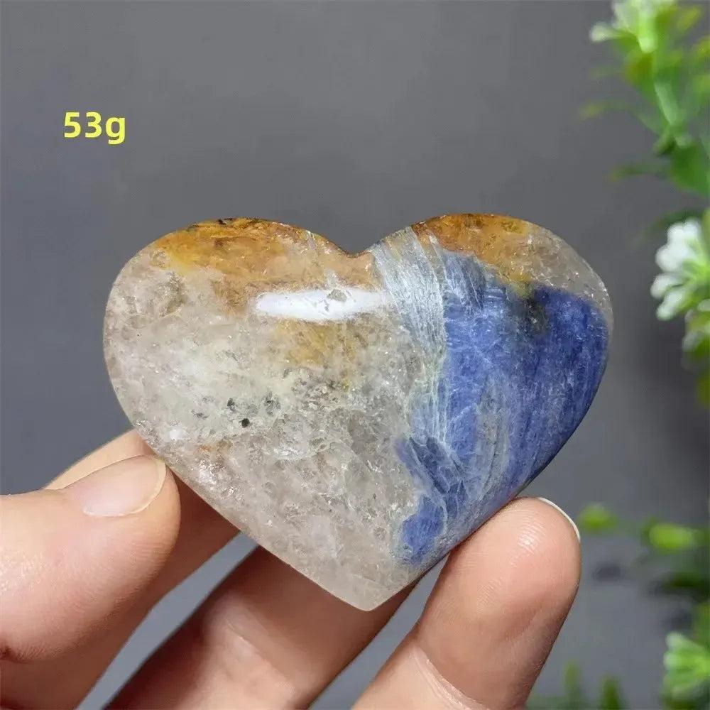 Blue Apatite Crystal Heart: Vibrant electric blue, clear, and golden crystal heart, 53g, held in hand.