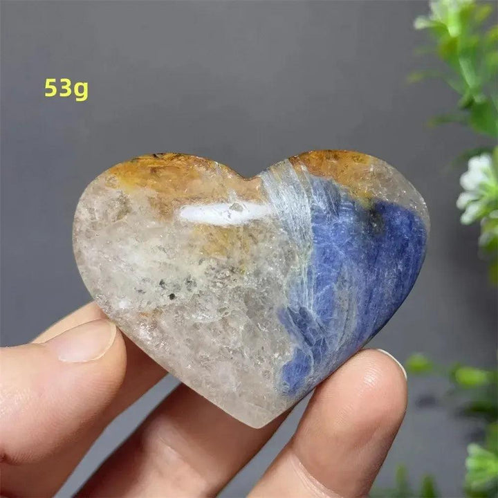 Blue Apatite Crystal Heart: Vibrant electric blue, clear, and golden crystal heart, 53g, held in hand.