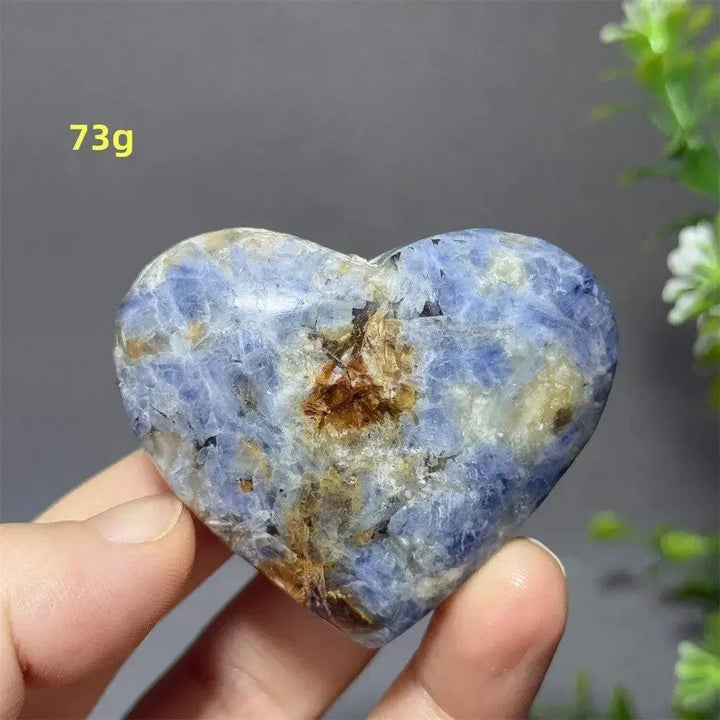 Captivating Blue Apatite Crystal Heart, 73g, with vibrant electric blue hues and natural inclusions, held in hand.