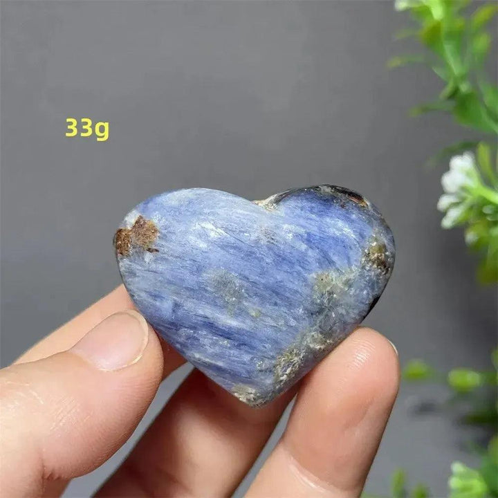 Captivating Blue Apatite Crystal Heart, 33g. Polished, electric blue stone with natural inclusions, held in hand.