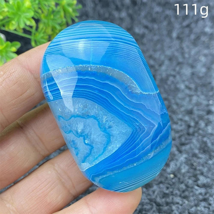 Polished 111g Blue Lace Agate palm stone featuring calming blue banded patterns and a soothing, natural crystal texture.