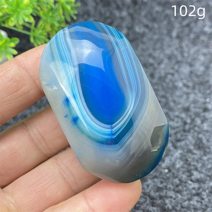 Polished 102g Blue Lace Agate palm stone featuring calming blue banded patterns, perfect for healing and home decor.
