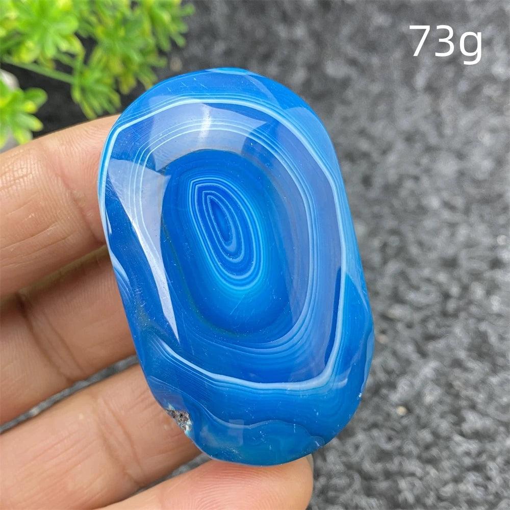 Polished 73g Blue Lace Agate palm stone with calming blue bands, perfect for Feng Shui, meditation, and home decor.