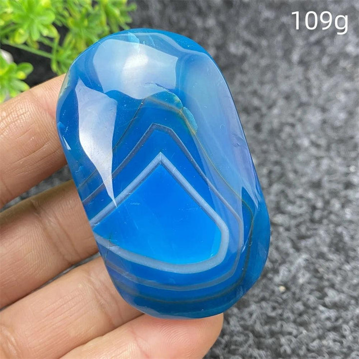 Polished 109g Blue Lace Agate palm stone with calming blue bands, perfect for healing, meditation, and home decor.