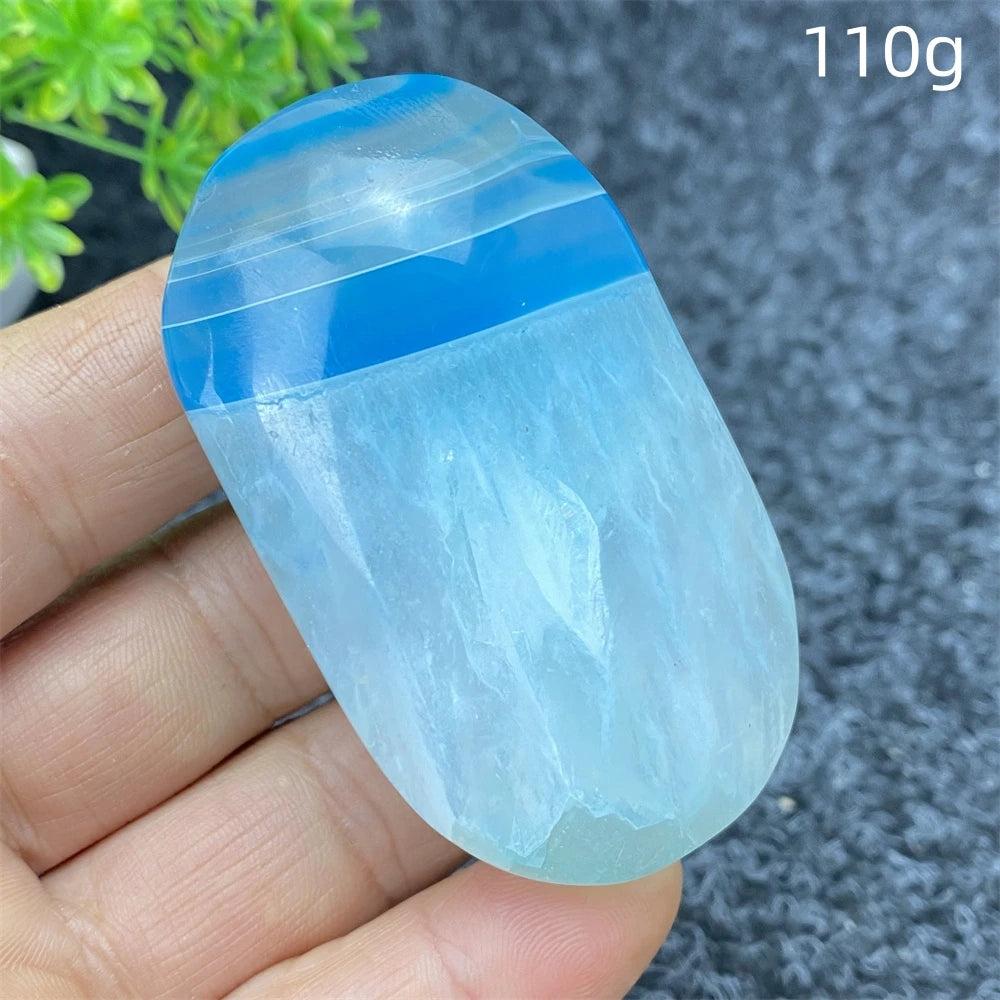 Polished 110g Blue Lace Agate palm stone with calming blue bands, perfect for healing, meditation, and home decor.