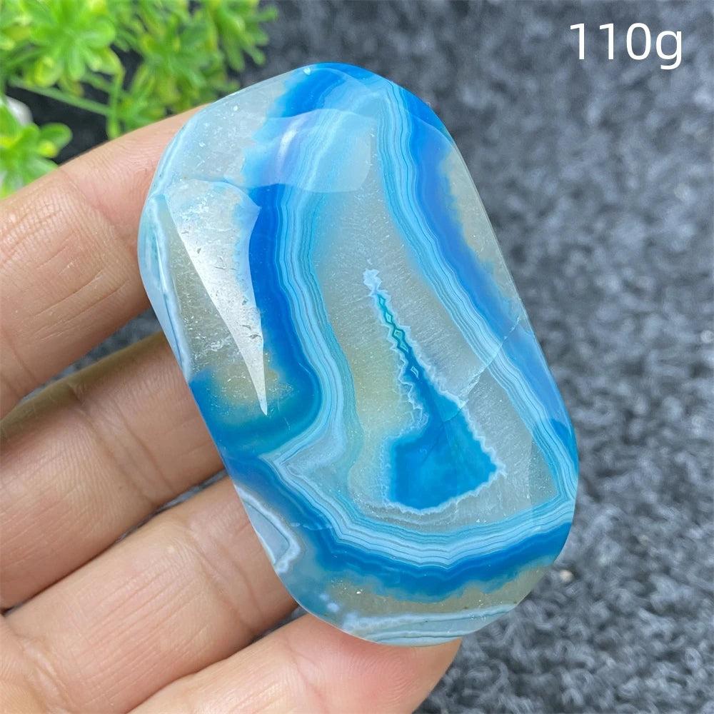 110g polished Blue Lace Agate palm stone with calming blue banded patterns, perfect for healing and home decor.