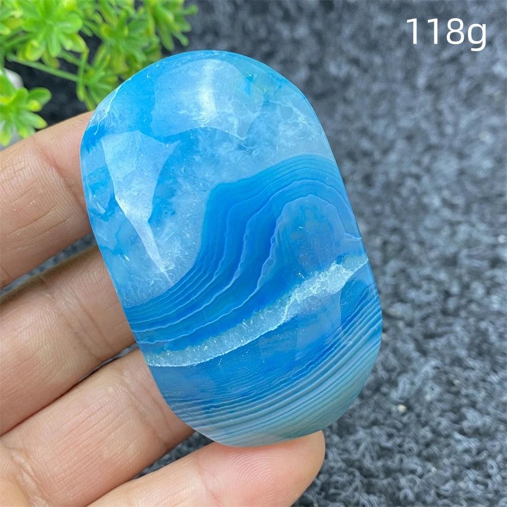 Polished 118g Blue Lace Agate palm stone with calming blue bands, perfect for soothing energy and home decor.