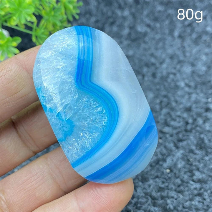 80g polished Blue Lace Agate palm stone with calming blue bands and a sparkling crystal center for healing decor.