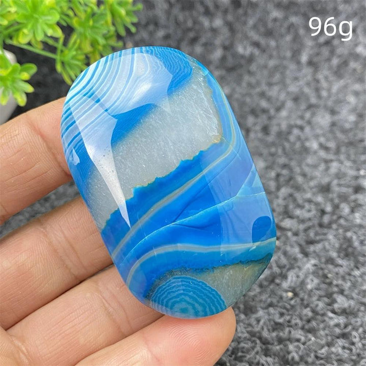 Polished 96g Blue Lace Agate palm stone with calming blue banded patterns, perfect for healing and home decor.