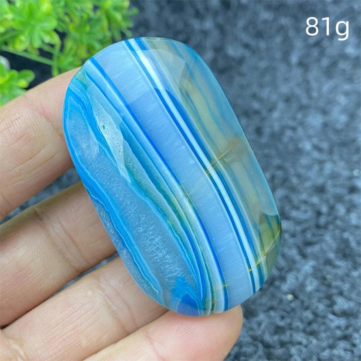 Polished 81g Blue Lace Agate palm stone featuring calming blue banded patterns, perfect for healing and home decor.