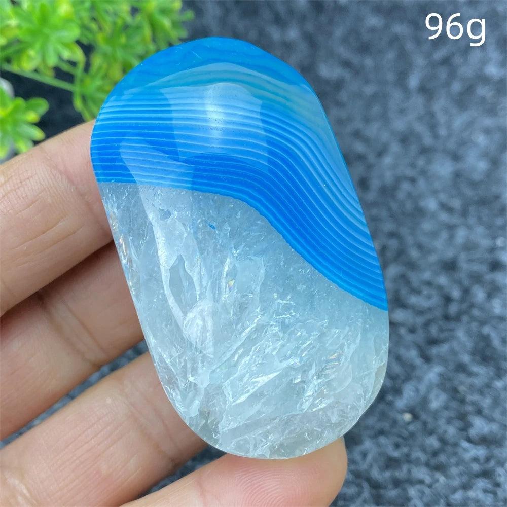 Hand-polished 96g Blue Lace Agate palm stone with calming blue banded patterns and clear crystal for healing and decor.