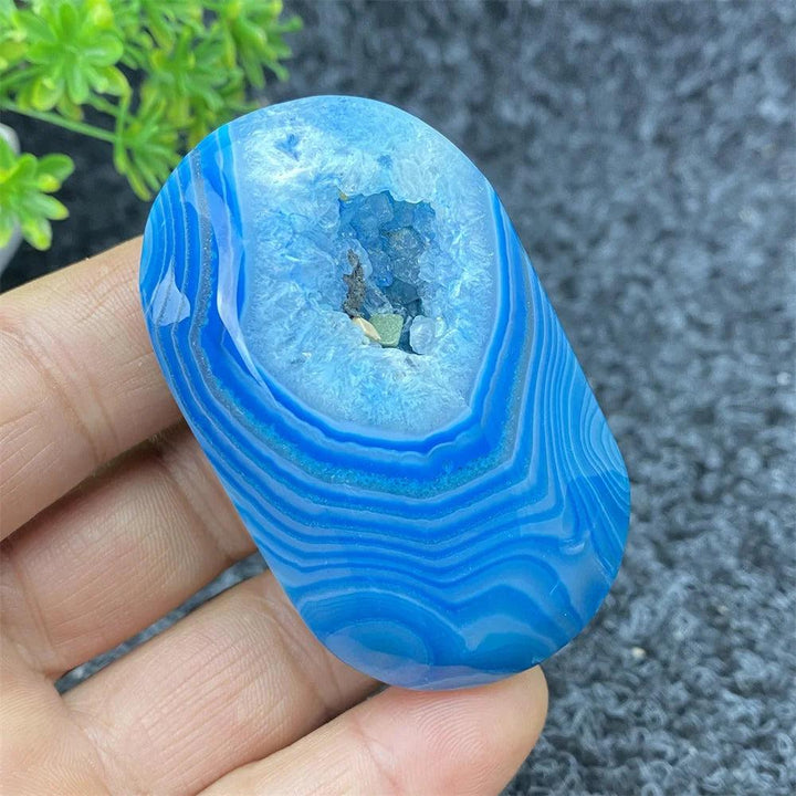 Polished Blue Lace Agate palm stone with a sparkling crystal geode center, perfect for calming energy and home decor.