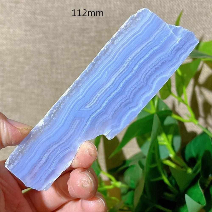 Polished Blue Lace Agate slab featuring calming pale blue and white lace-like bands for throat chakra healing and display.