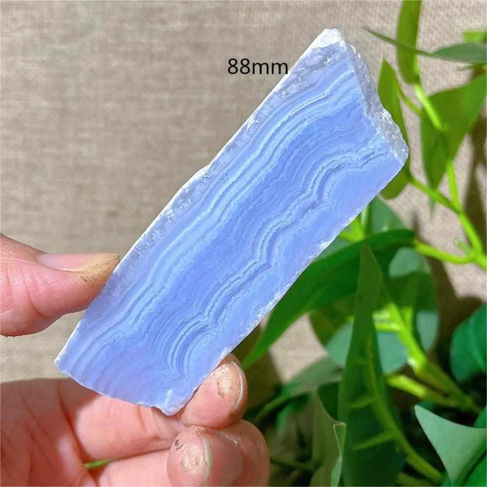 Polished Blue Lace Agate slab featuring delicate pale blue and white bands for calming Throat Chakra energy.