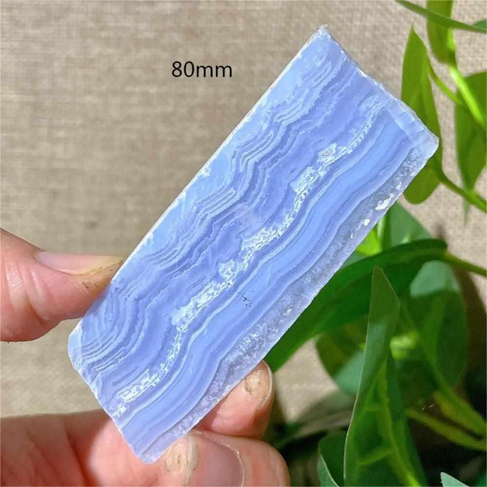 Polished Blue Lace Agate slab featuring calming pale blue and white lace-like bands for Throat Chakra healing and display.