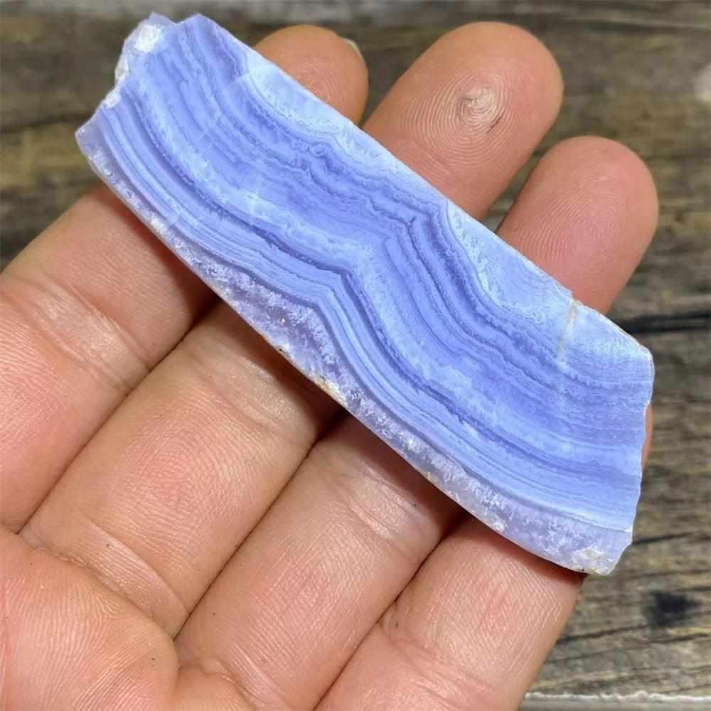 Polished Blue Lace Agate slab featuring calming pale blue and white lace-like bands for Throat Chakra healing and display.