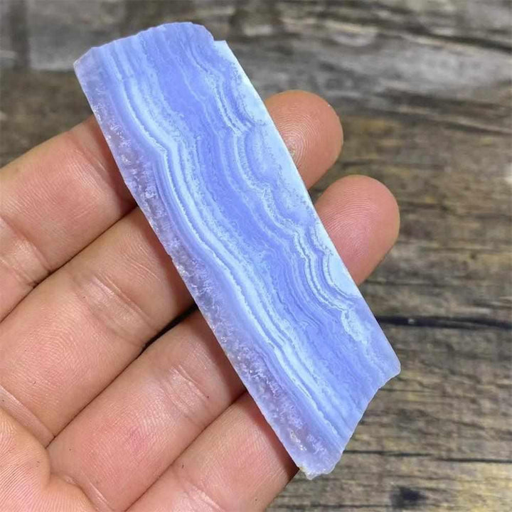 Polished Blue Lace Agate slab featuring calming pale blue and white lace-like bands for Throat Chakra healing and display.