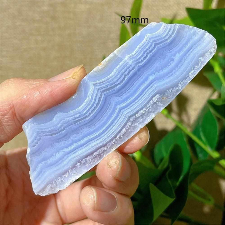 Polished Blue Lace Agate slab featuring calming pale blue and white lace-like bands for throat chakra healing and display.