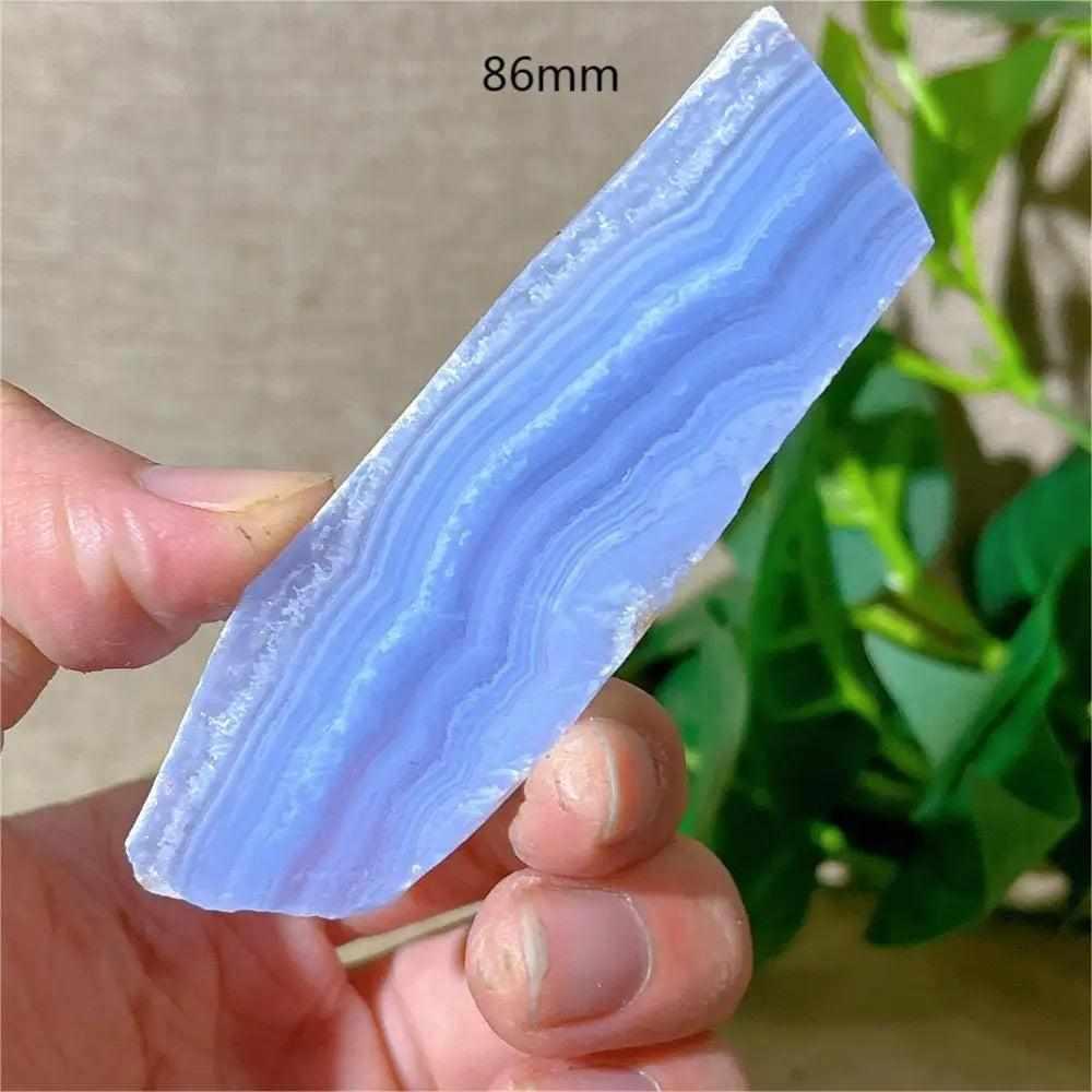 Polished Blue Lace Agate slab featuring calming pale blue and white lace-like bands for Throat Chakra healing and display.