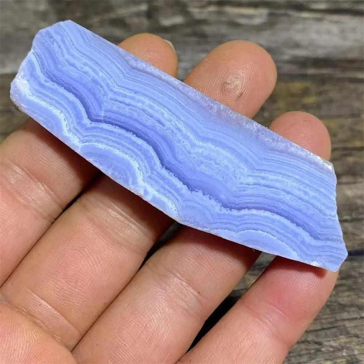 Polished Blue Lace Agate slab featuring delicate pale blue and white bands for calming Throat Chakra energy.