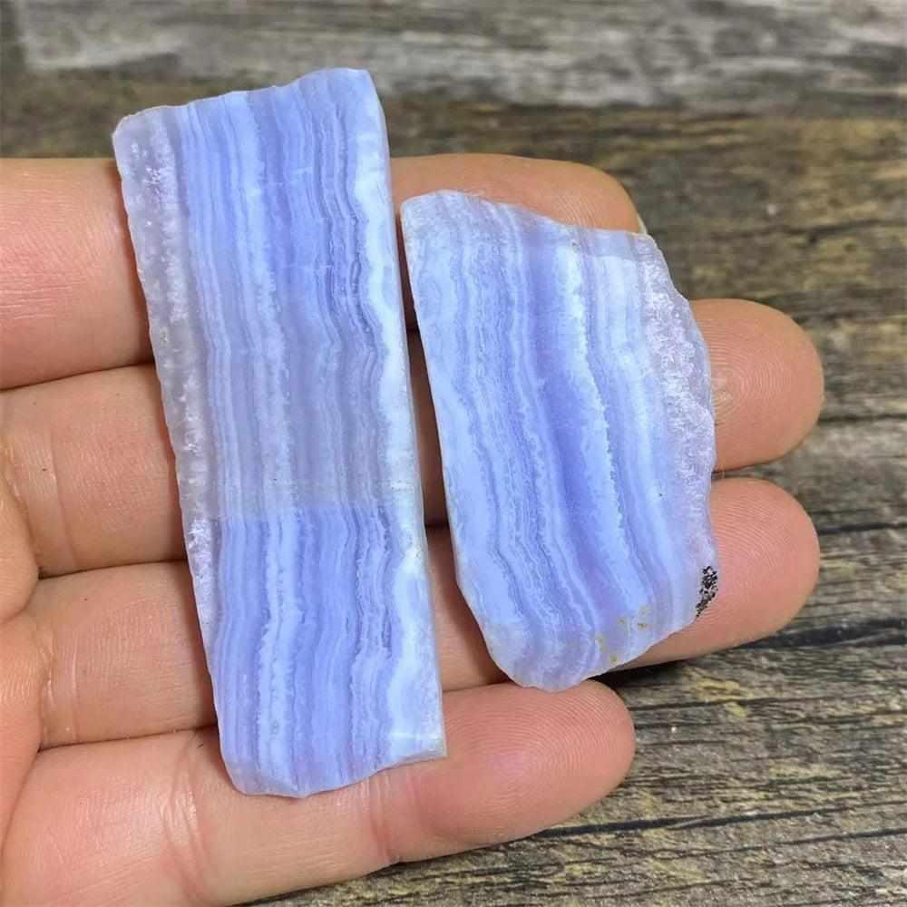 Polished Blue Lace Agate slab with calming pale blue and white lace-like bands for Throat Chakra healing and desk decor.