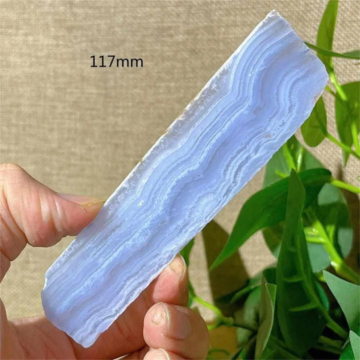 Polished Blue Lace Agate slab with soothing pale blue and white bands, perfect for calming Throat Chakra energy.