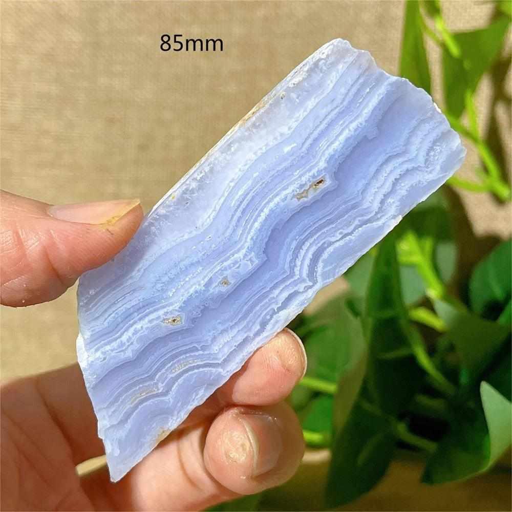 Polished Blue Lace Agate slab featuring calming pale blue and white lace-like bands for Throat Chakra healing.
