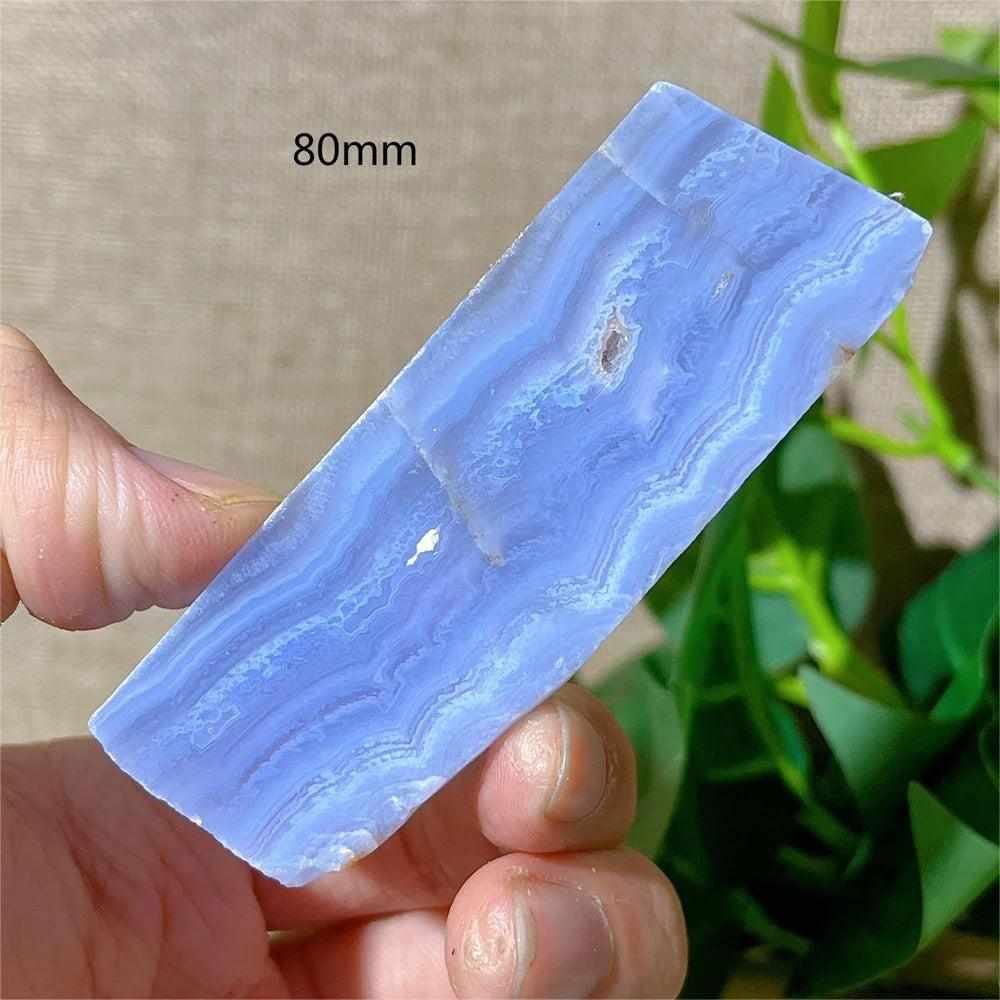 Polished Blue Lace Agate slab with soothing pale blue and white bands, perfect for Throat Chakra healing and desk decor.