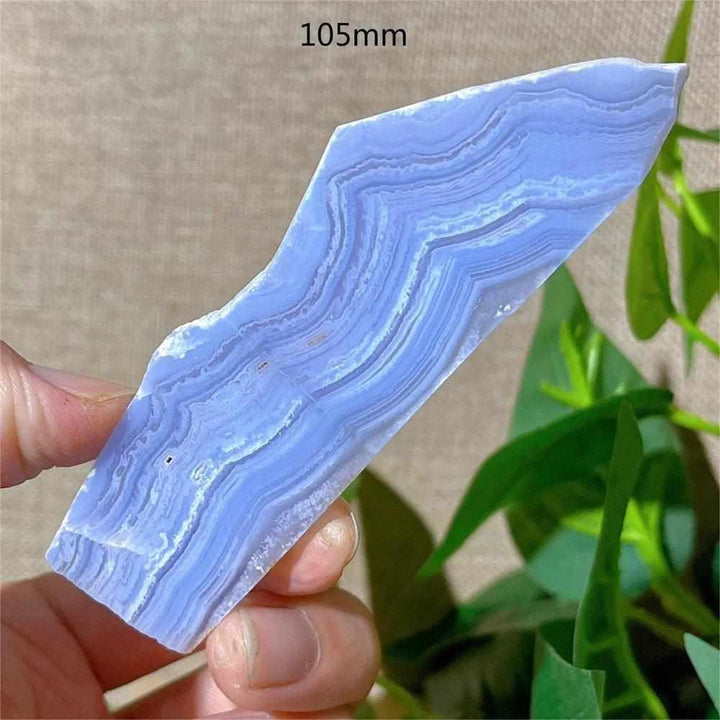 Polished Blue Lace Agate slab featuring soothing pale blue and white lace-like bands for calming Throat Chakra energy.