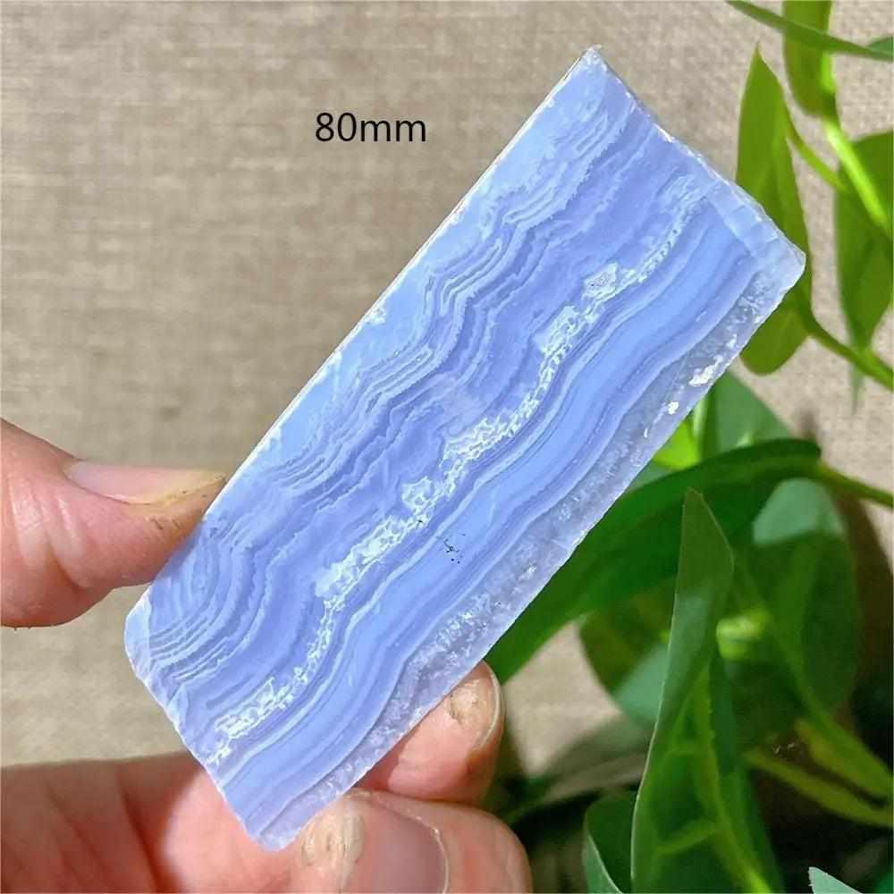 Polished Blue Lace Agate slab featuring calming pale blue and white lace-like bands for throat chakra healing.
