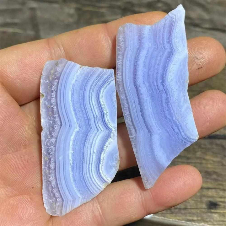 Polished Blue Lace Agate slab with calming pale blue and white lace-like bands for Throat Chakra healing and desk decor.