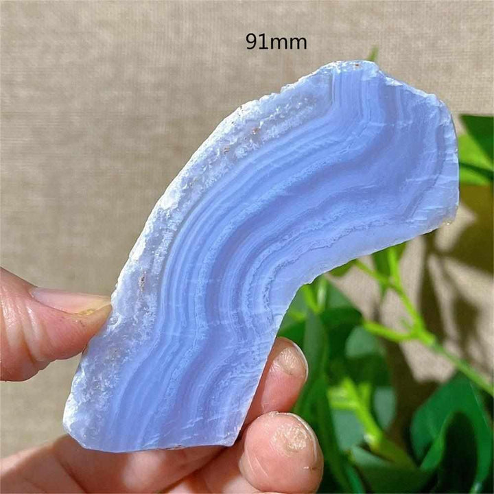 Polished Blue Lace Agate slab featuring calming pale blue and white lace-like bands for Throat Chakra healing.