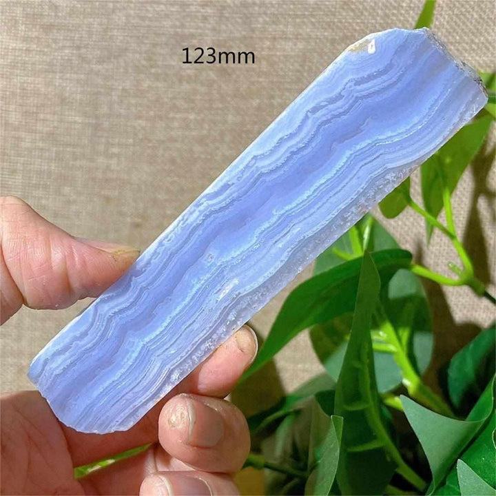 Polished Blue Lace Agate slab featuring calming pale blue and white lace-like bands for throat chakra healing and decor.