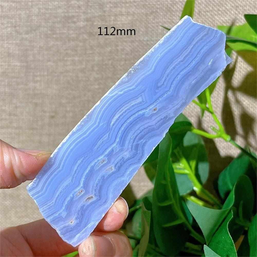 Polished Blue Lace Agate slab featuring calming pale blue and white lace-like bands for Throat Chakra healing.