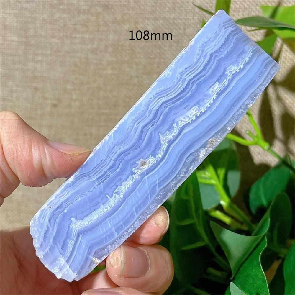 Polished Blue Lace Agate slab with delicate pale blue and white bands, perfect for throat chakra calming and decor.