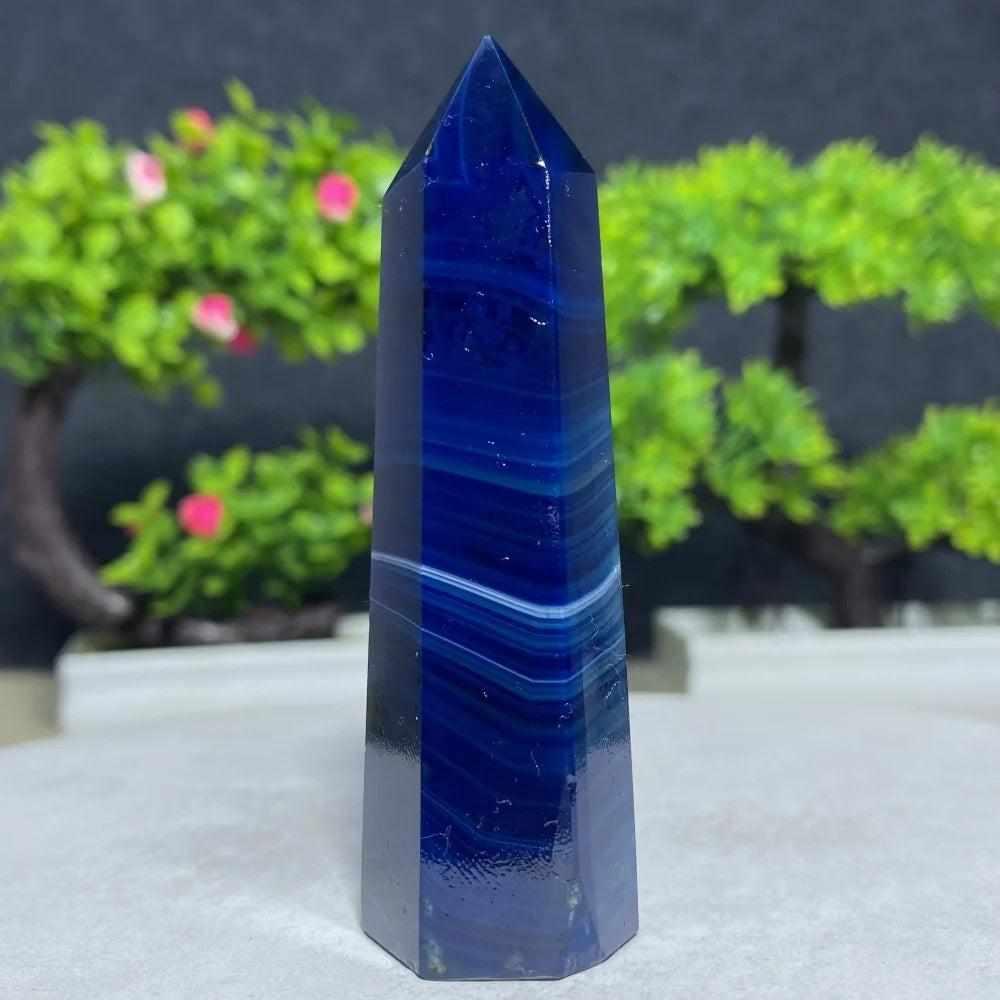 Polished Blue Lace Agate tower featuring deep blue hues and calming white bands, perfect for throat chakra healing.