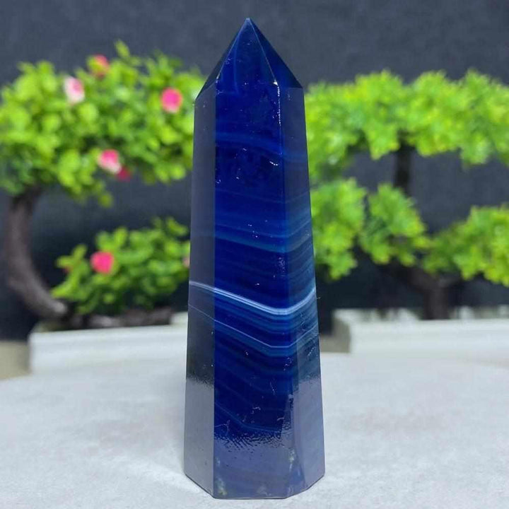 Polished Blue Lace Agate tower featuring deep blue hues and calming white bands, perfect for throat chakra healing.