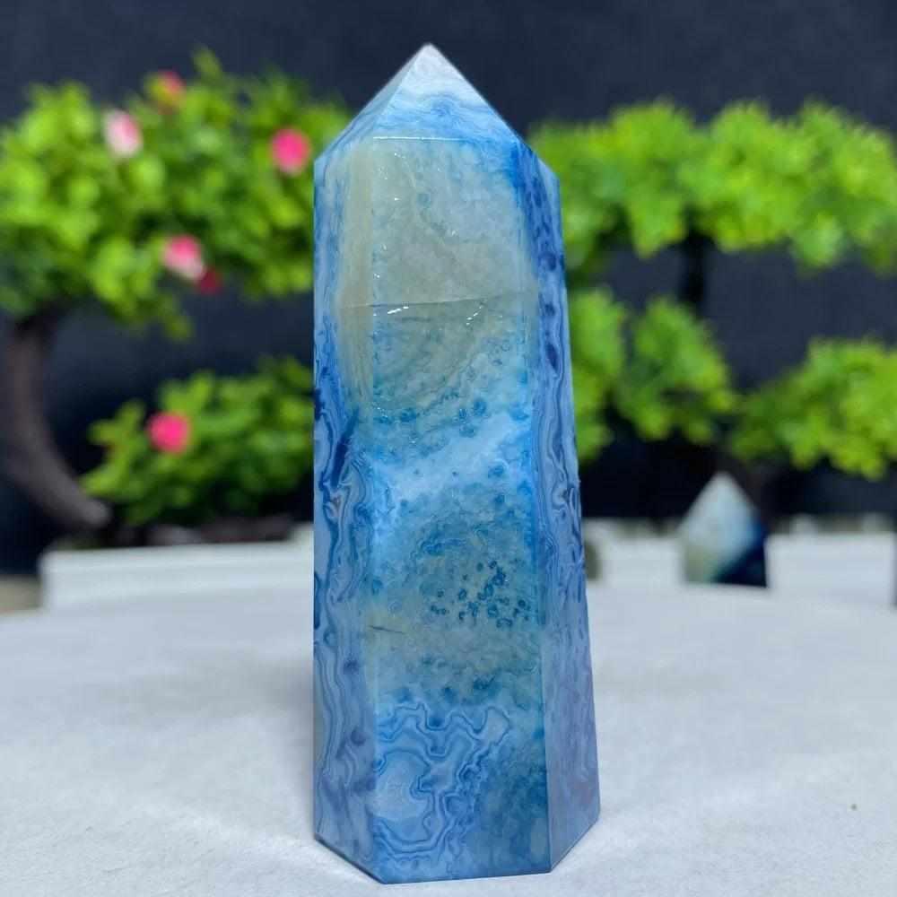 Polished Blue Lace Agate tower featuring calming sky-blue and white lace-like bands for throat chakra healing and tranquility.