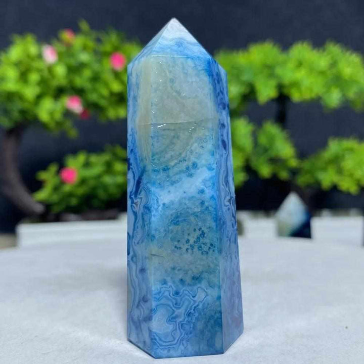 Polished Blue Lace Agate tower featuring calming sky-blue and white lace-like bands for throat chakra healing and tranquility.