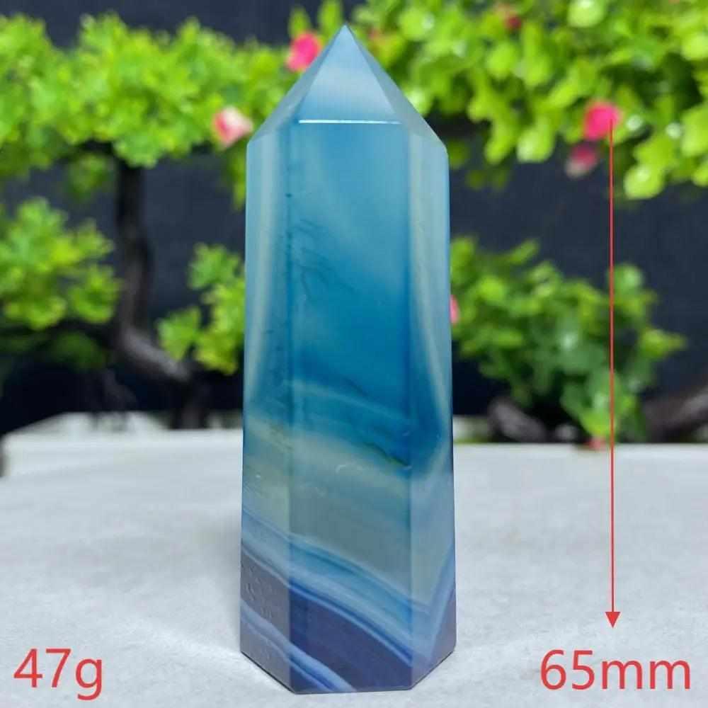Polished Blue Lace Agate tower featuring calming sky blue and white ripples to soothe the throat chakra and ease tension.