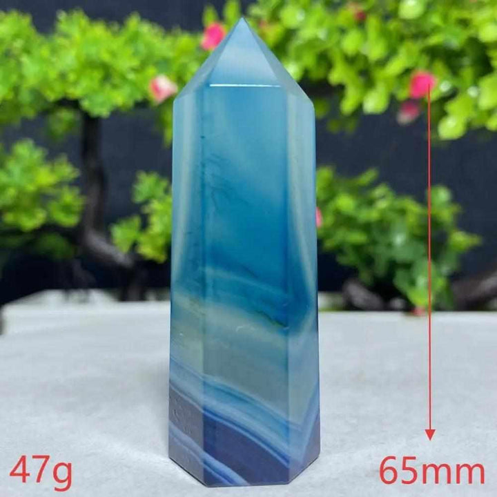 Polished Blue Lace Agate tower featuring calming sky blue and white ripples to soothe the throat chakra and ease tension.