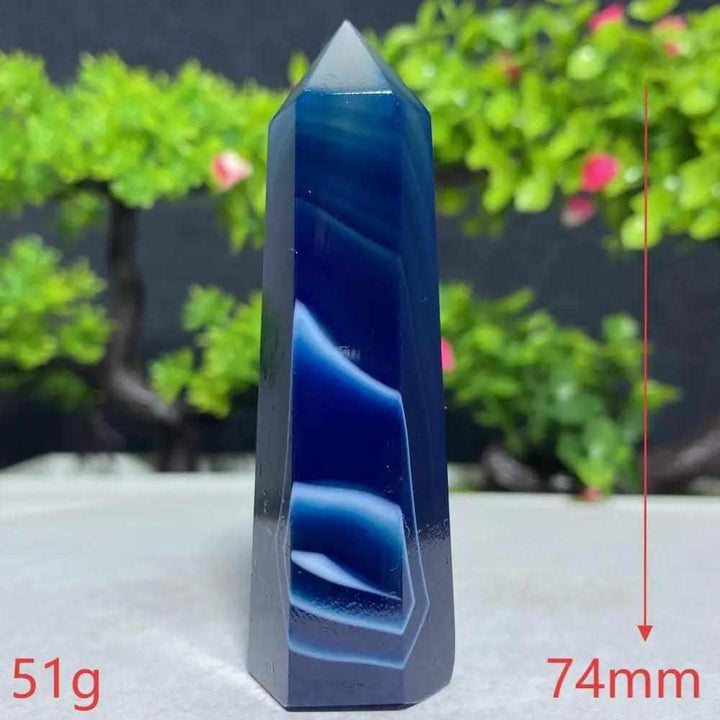 Polished Blue Lace Agate tower with calming deep blue and white bands, perfect for throat chakra healing and tranquility.