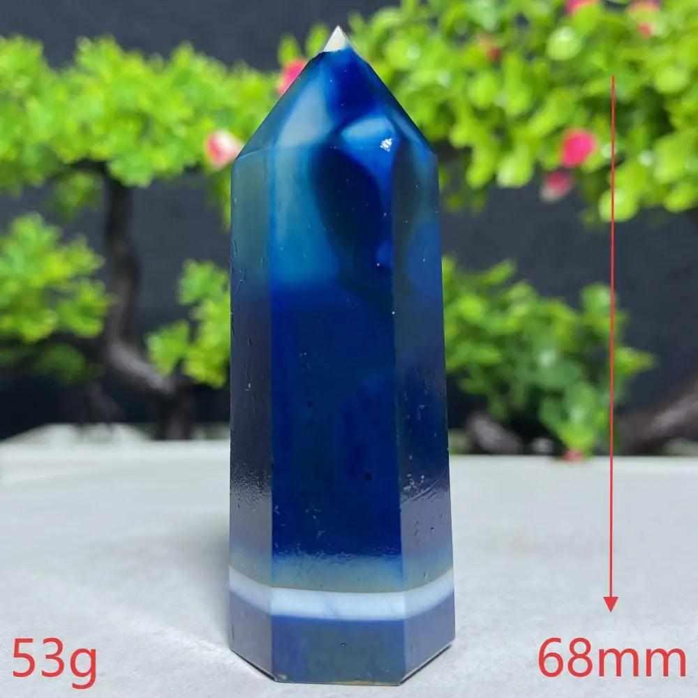 Polished Blue Lace Agate tower featuring deep blue hues and calming white bands for throat chakra healing and tranquility.