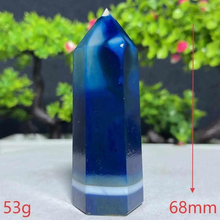 Polished Blue Lace Agate tower featuring deep blue hues and calming white bands for throat chakra healing and tranquility.