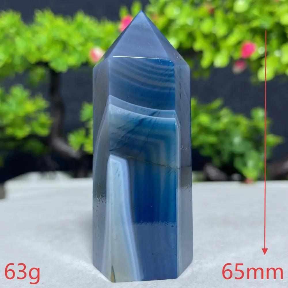 Polished Blue Lace Agate tower featuring calming sky-blue and white bands to soothe the throat chakra and promote peace.
