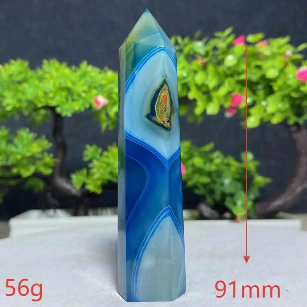 Polished Blue Lace Agate tower with calming sky-blue and white bands, perfect for throat chakra healing and tranquility.