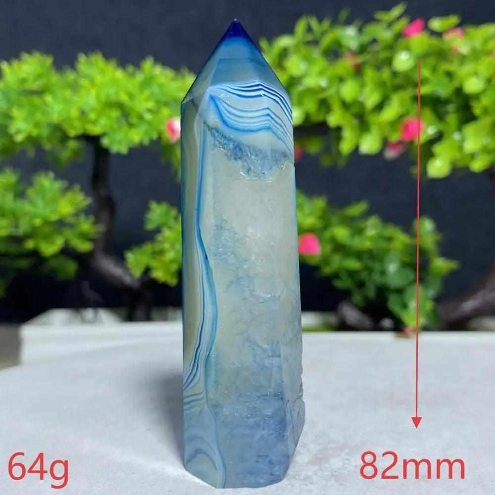 Polished Blue Lace Agate tower featuring calming sky-blue and white bands for throat chakra healing and peaceful energy.