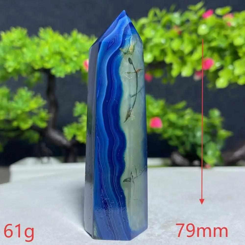 Polished Blue Lace Agate tower featuring calming sky-blue and white bands for throat chakra healing and peaceful energy.