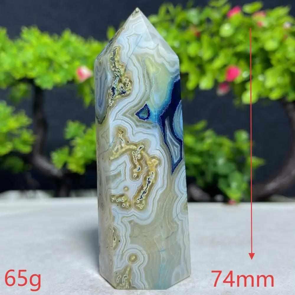 Polished Blue Lace Agate tower featuring calming sky blue and white ripples, perfect for throat chakra healing.