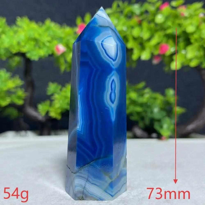 Polished Blue Lace Agate tower with calming sky-blue and white bands, perfect for throat chakra healing and tranquility.